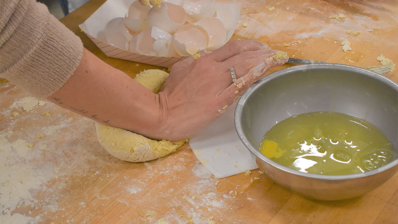 Closeup of hands kneading dough